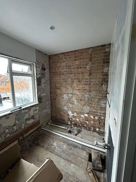 The same bathroom stripped back to bare brick before the SWW refit