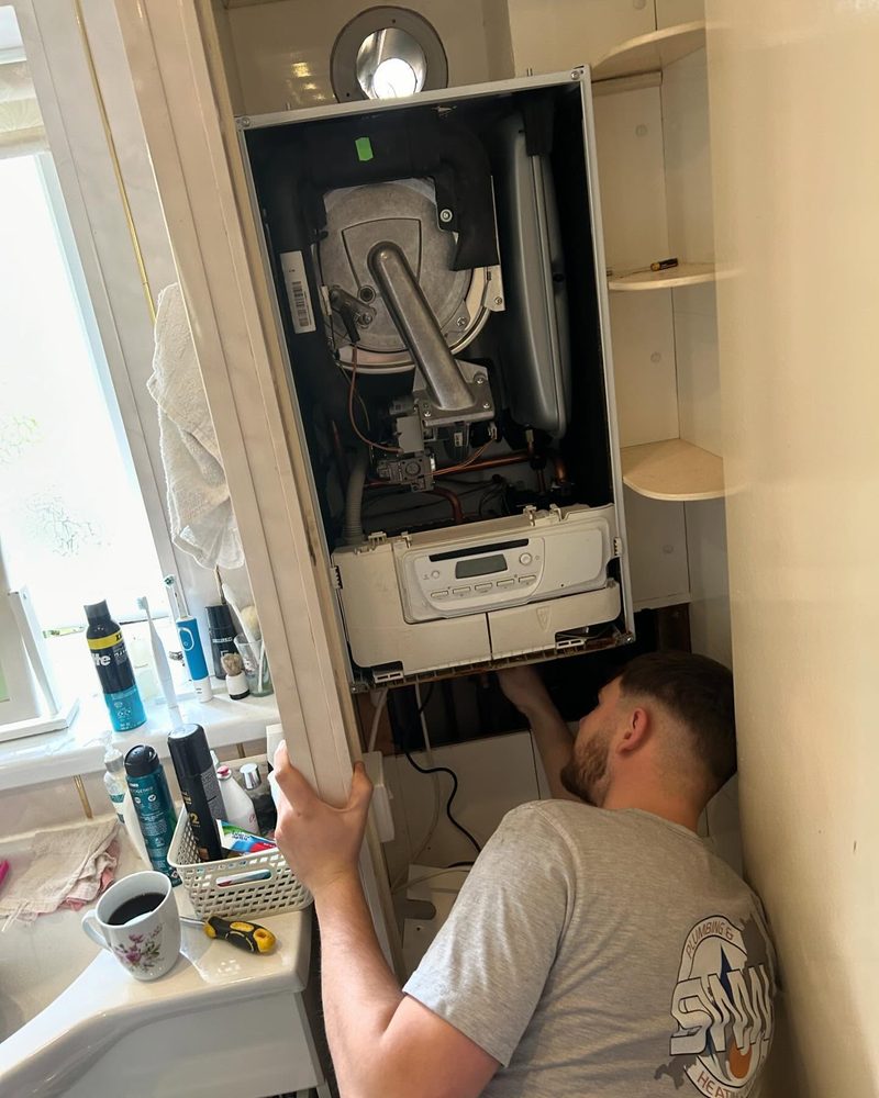 SWW engineer servicing a boiler in Exeter using a flue gas analyser