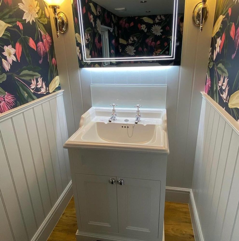 Traditional cloakroom with a period basin, LED mirror and floral wallpaper
