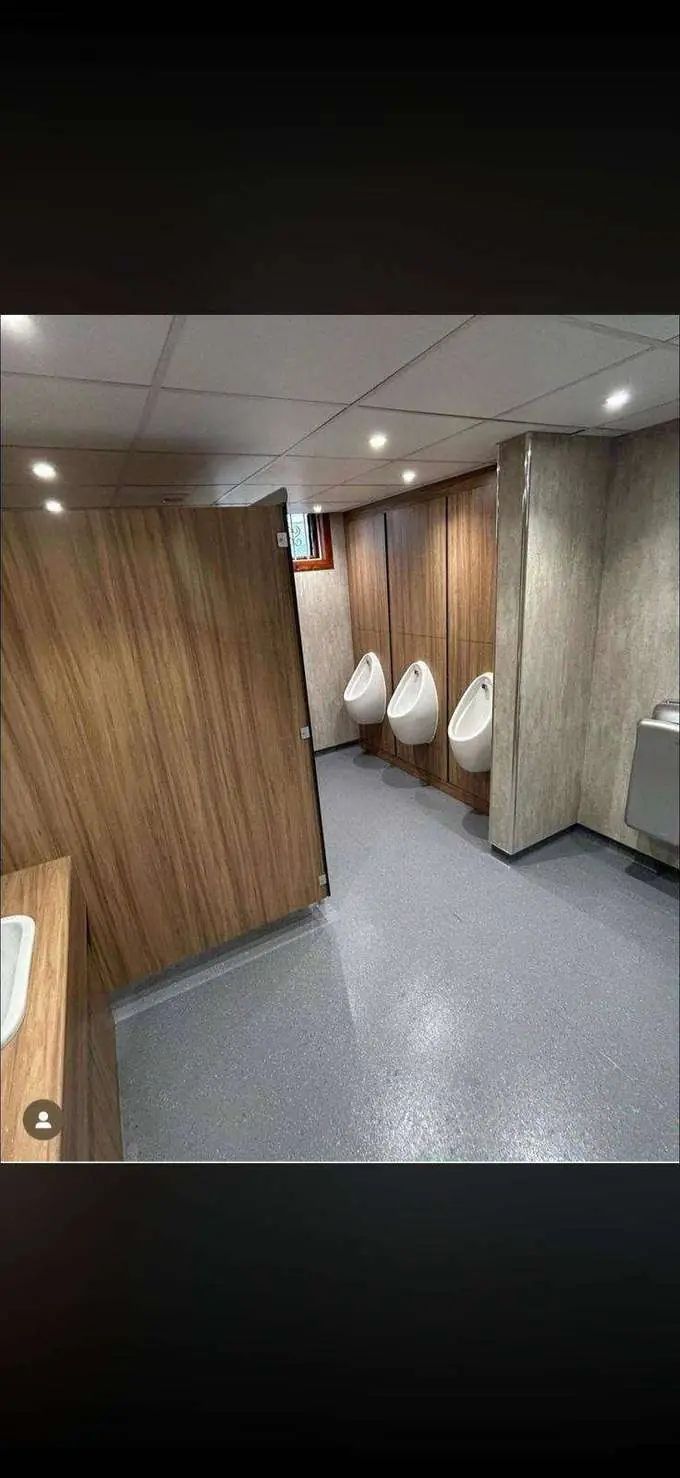 Finished urinal area with walnut surround