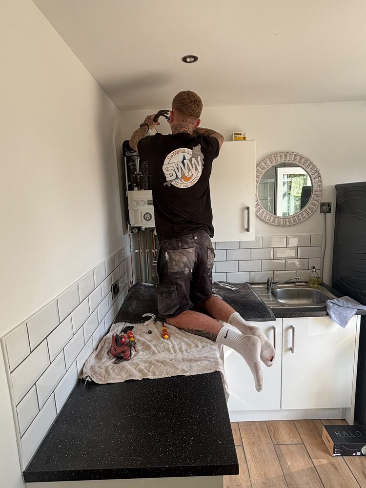 Old boiler being removed by SWW ahead of an Ideal install
