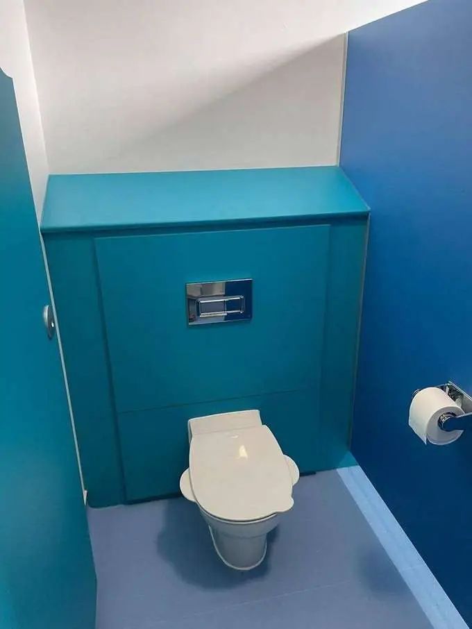 New wall-hung WC with concealed cistern in finished cubicle