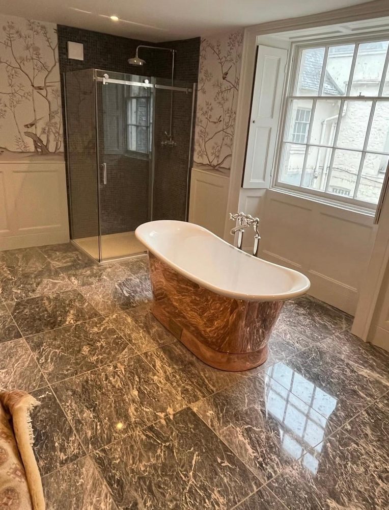Period bathroom fitted by SWW with a copper boat bath, walk-in shower and marble floor
