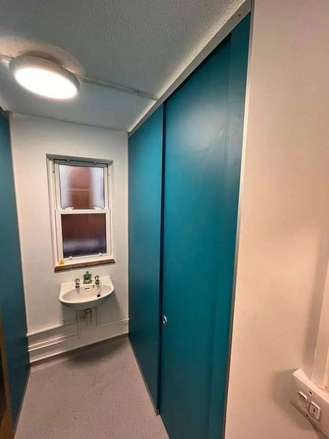 Solid-grade laminate cubicle doors in teal finish